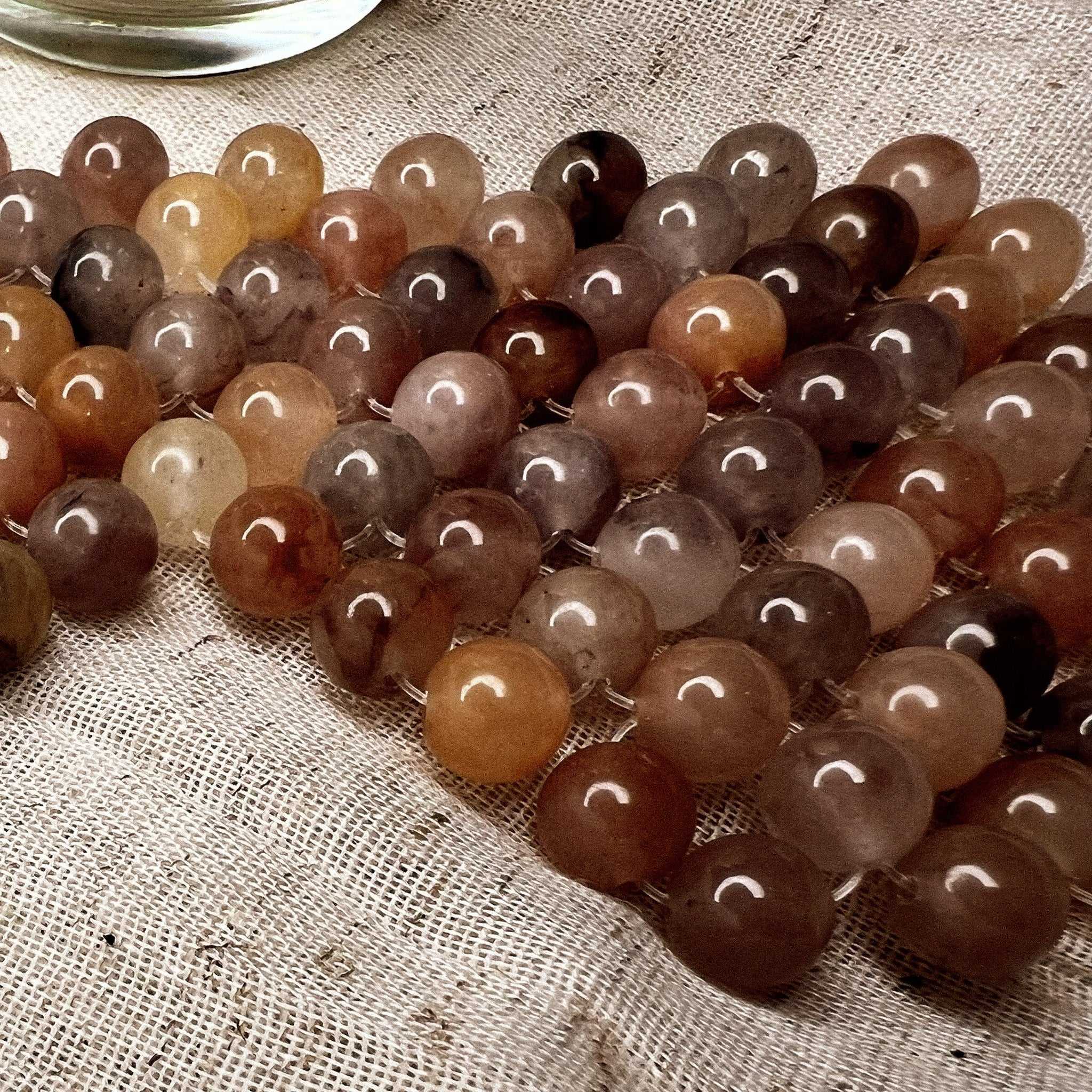 natural jade stone eye mask on fabric surface showcasing multicolored jade stones
